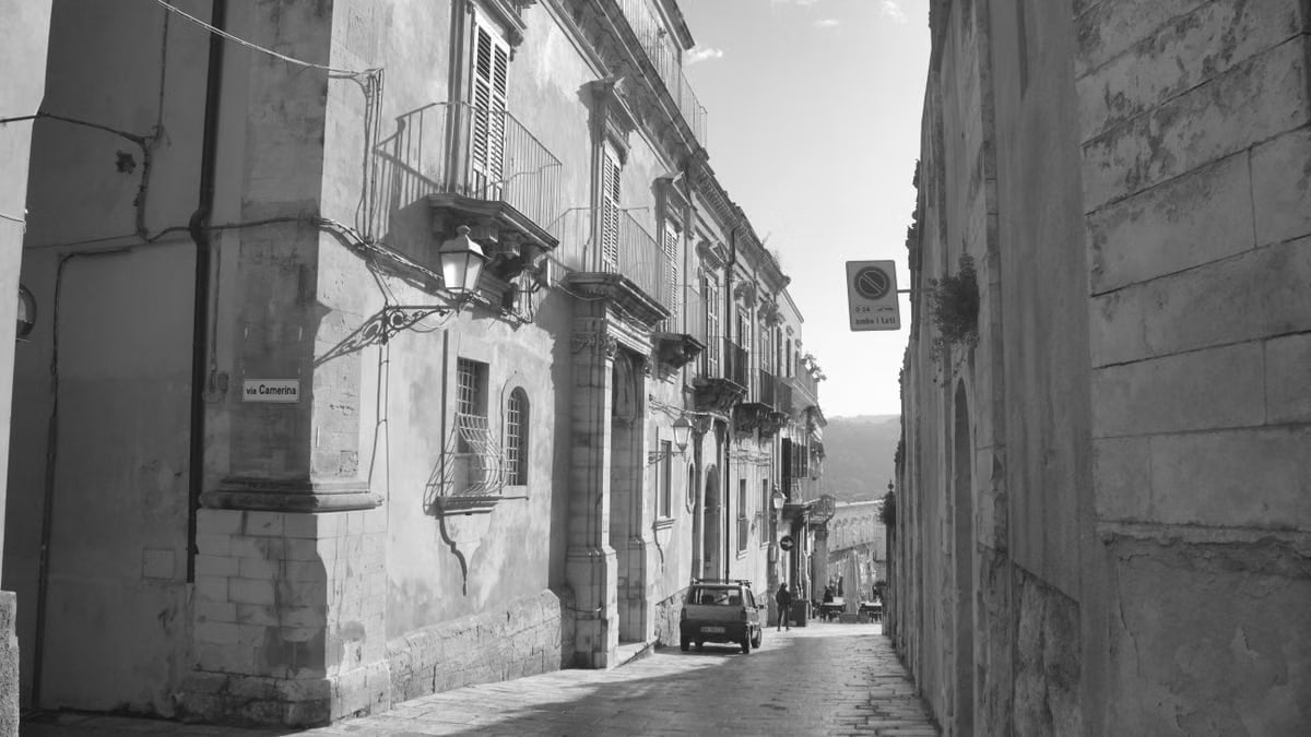 Charming street view in Ragusa, Sicily with baroque architecture, capturing Italian heritage.